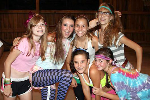 Camper girls dancing and dressed to the 1980s
