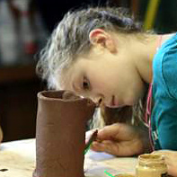 kid makes ceramics project at summer camp