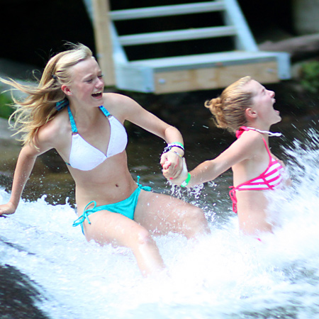 girls splashing into sliding rock pool