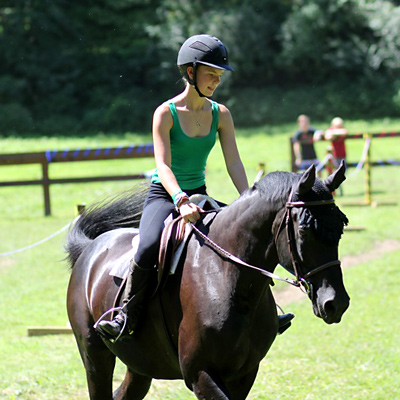 Girl riding a horse in the sun