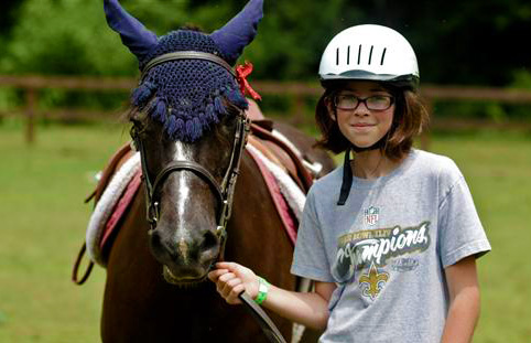 Girl and horse at equestrian camp