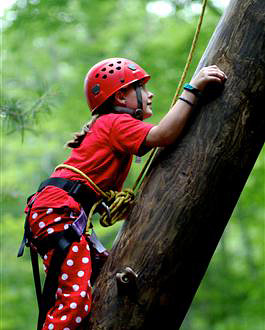 Camp girls climbing tower wearing polka dot pants