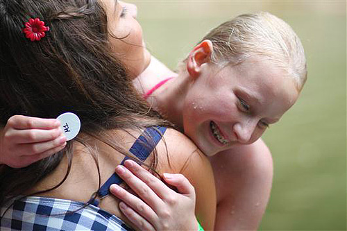 Girl receiving swim tag at summer camp