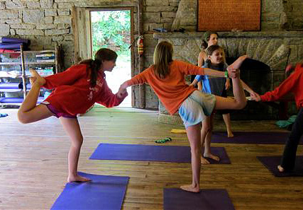 Girls yoga class pair pose