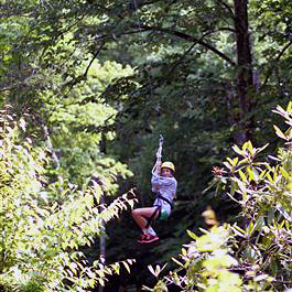 Girl camper riding the Rockbrook Camp zip line