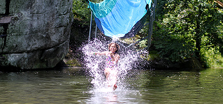 Camp Kid splashing down off the waterslide