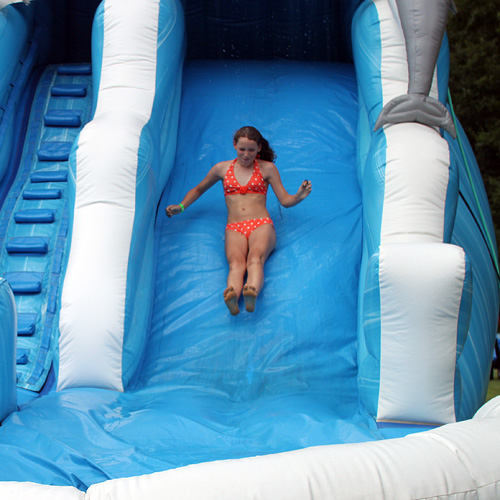 Camp girl slides down inflated slide