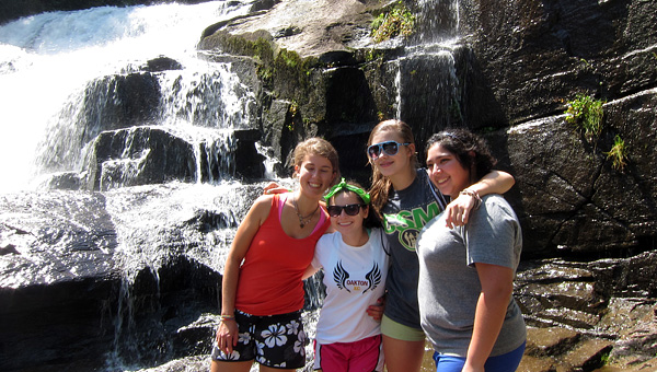 Camp girls hike near waterfall