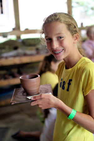 Girl show success on the pottery wheel