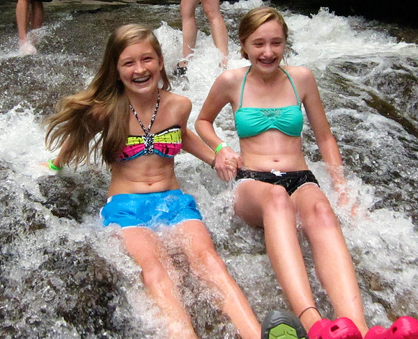 Camp girls smile going down sliding rock