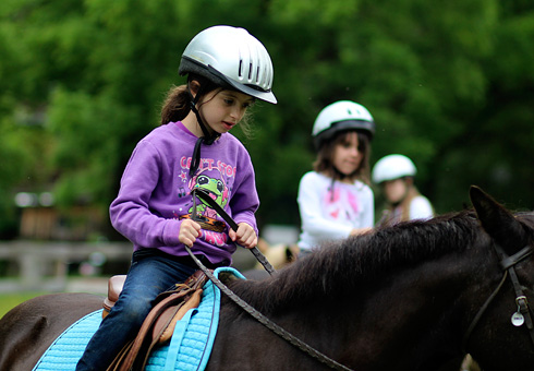 Camp child riding a horse