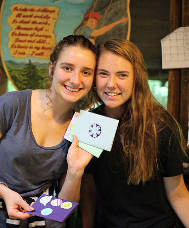 Girls holding cards made at camp