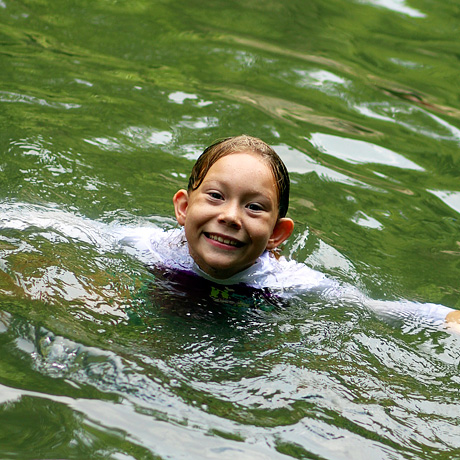Girl swimming at summer camp