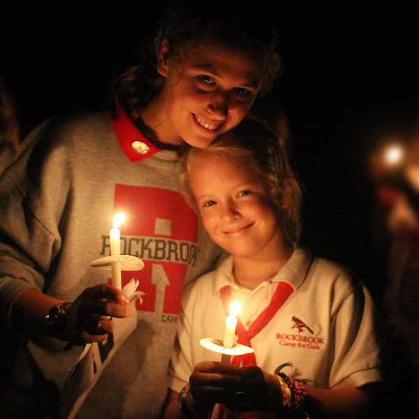 Camper and counselor at closing campfire