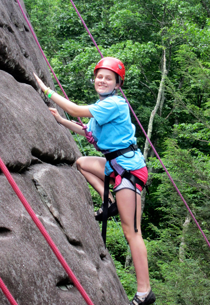 Camp girl rock climbing