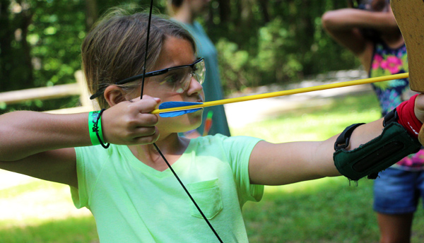 Junior camp girl shooting archery