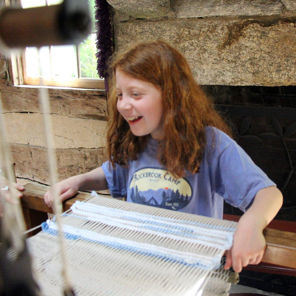 girl weaving on loom