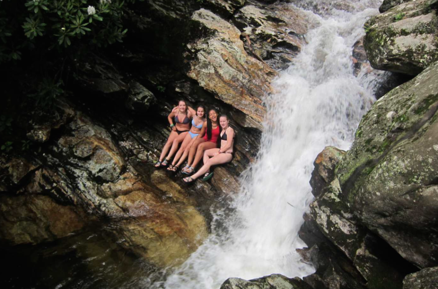 Girls next to waterfall