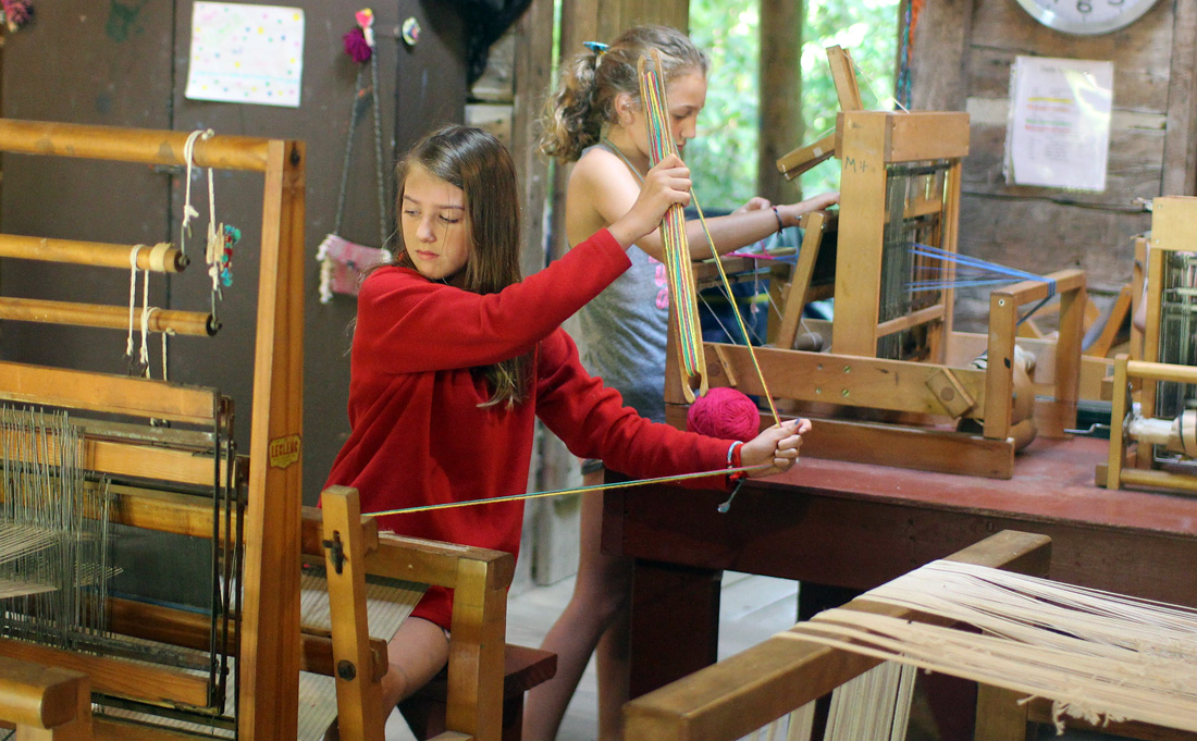 girls weaving looms