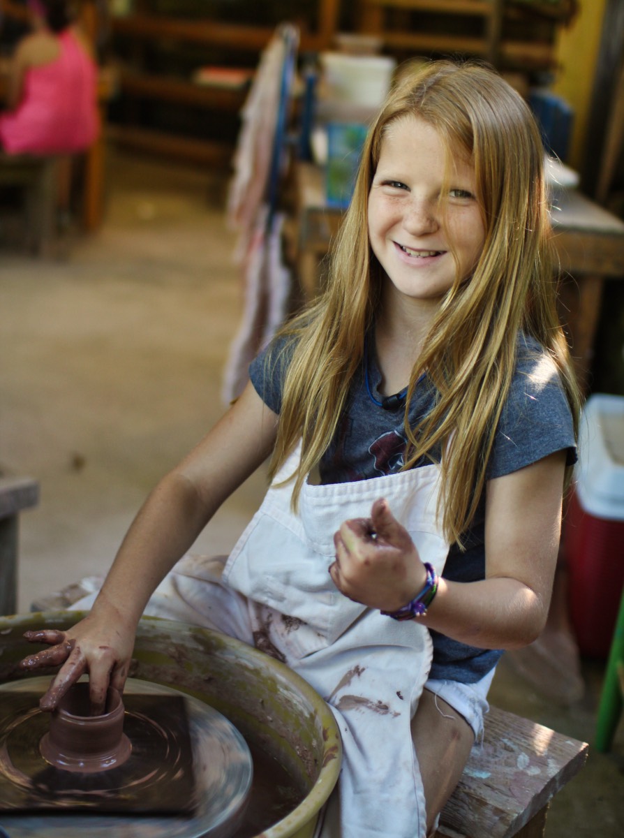 Smiling pottery wheel child