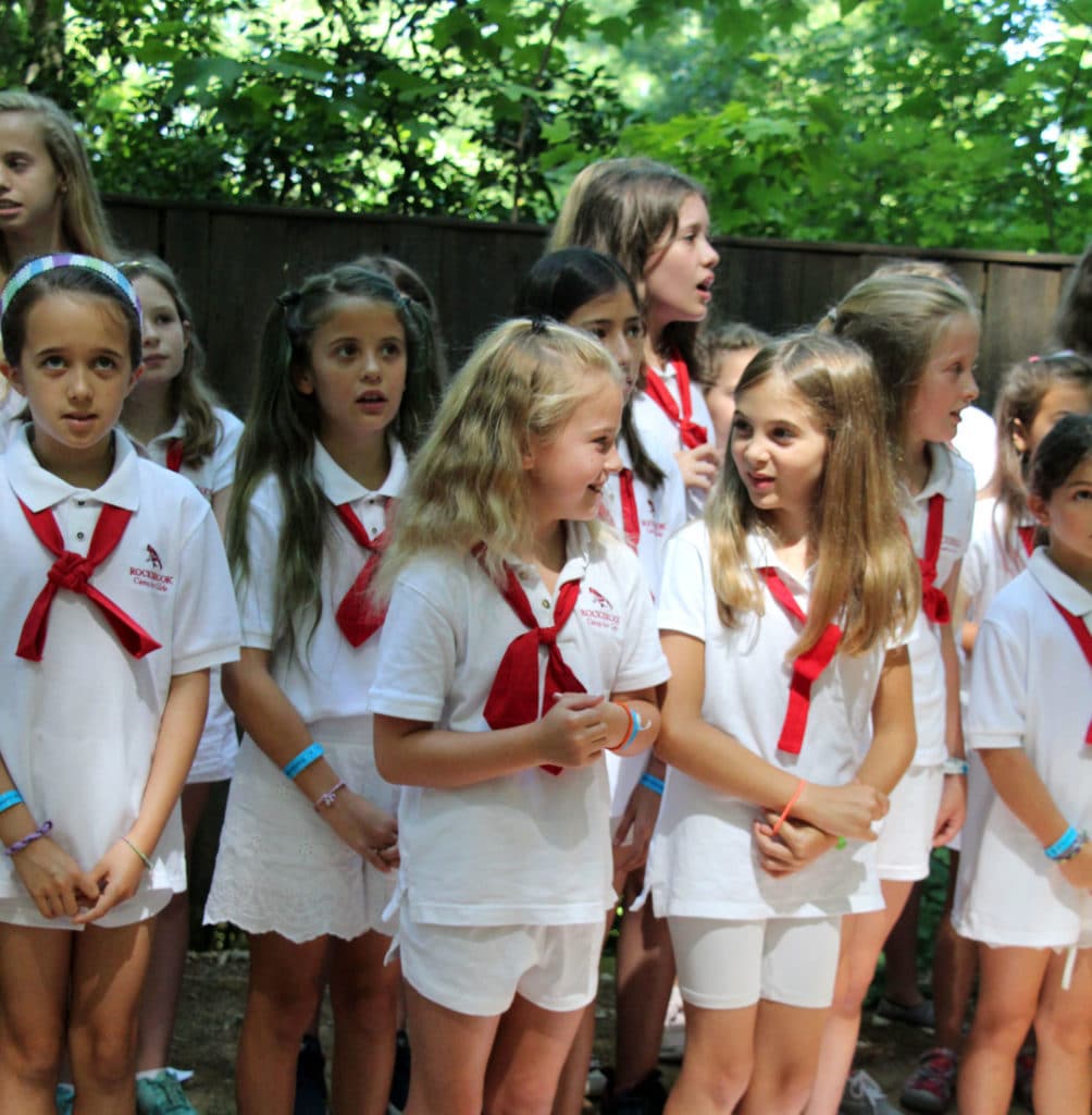 camp girls wearing white uniforms