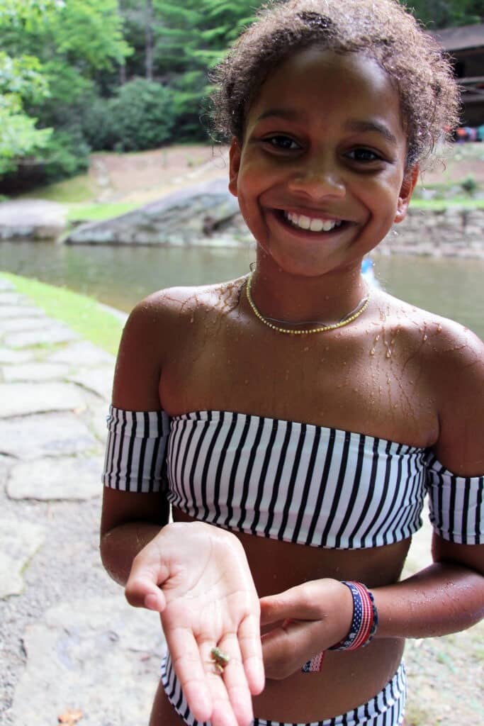 girl holding tadpole