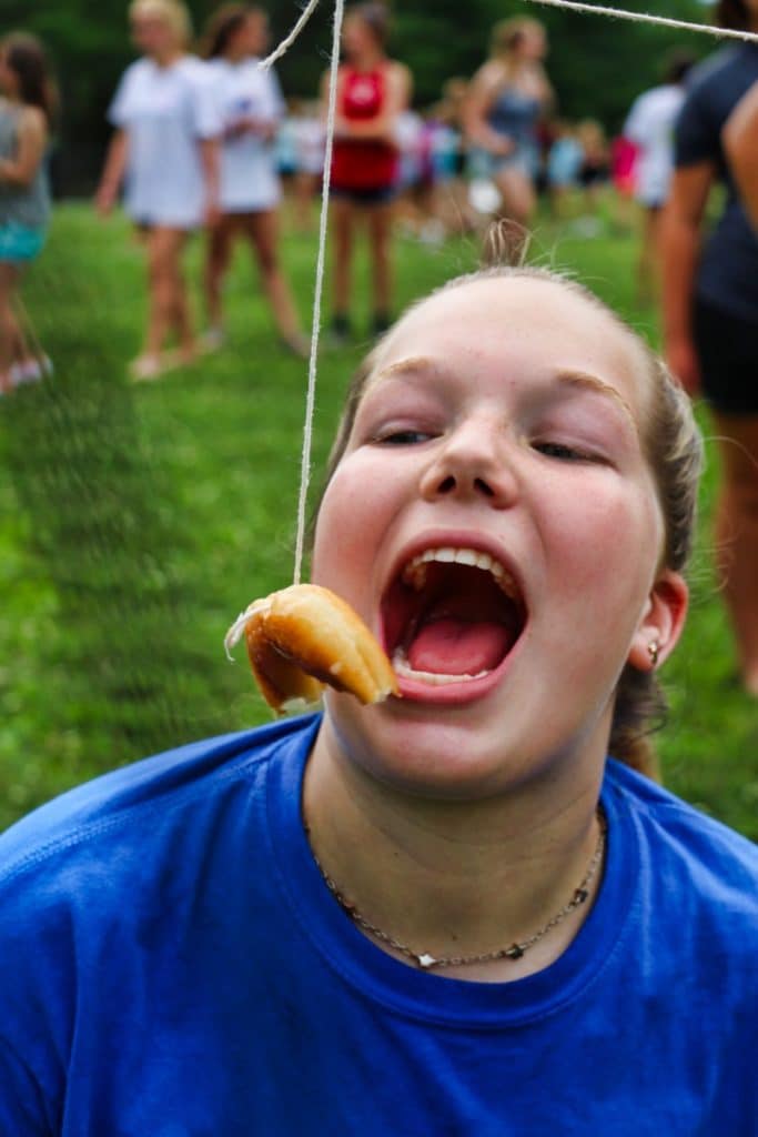 eating a donut on a string