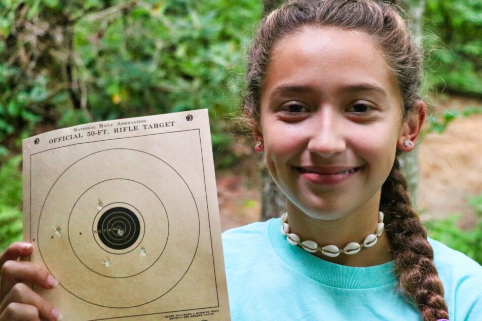 proud rifle girl holding target