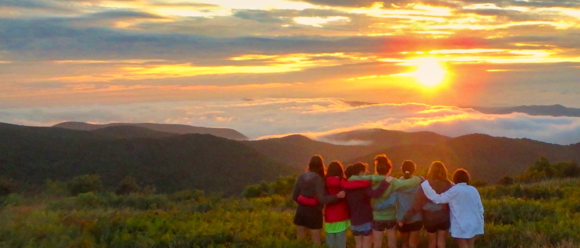camp girls watching mountain view sunset