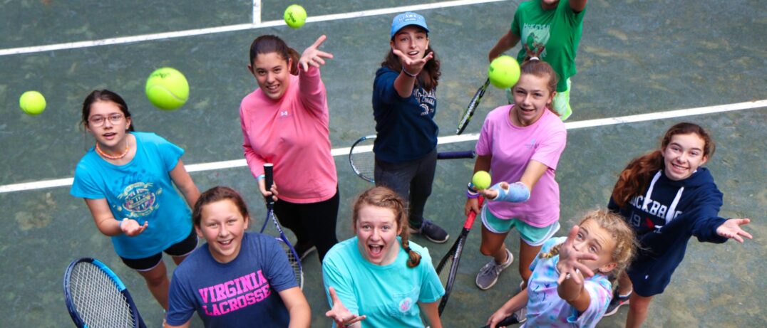 camp girls tossing tennis balls