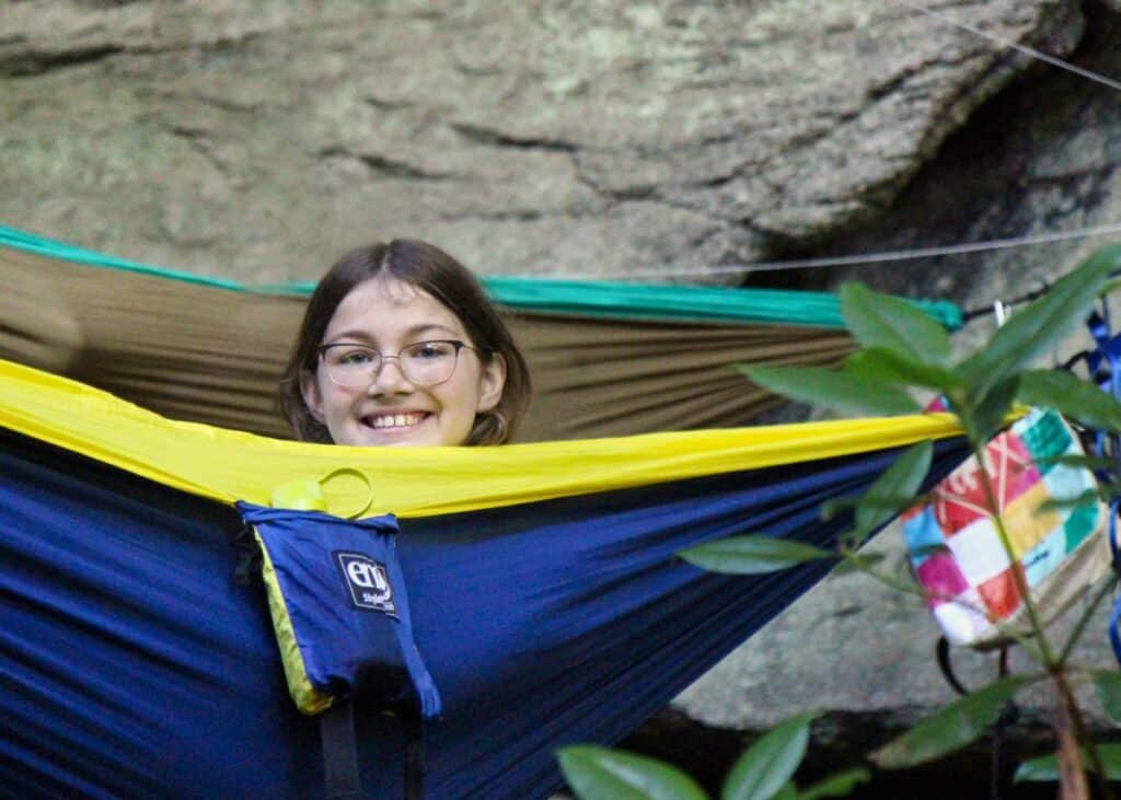 camp girl in nest of hammocks