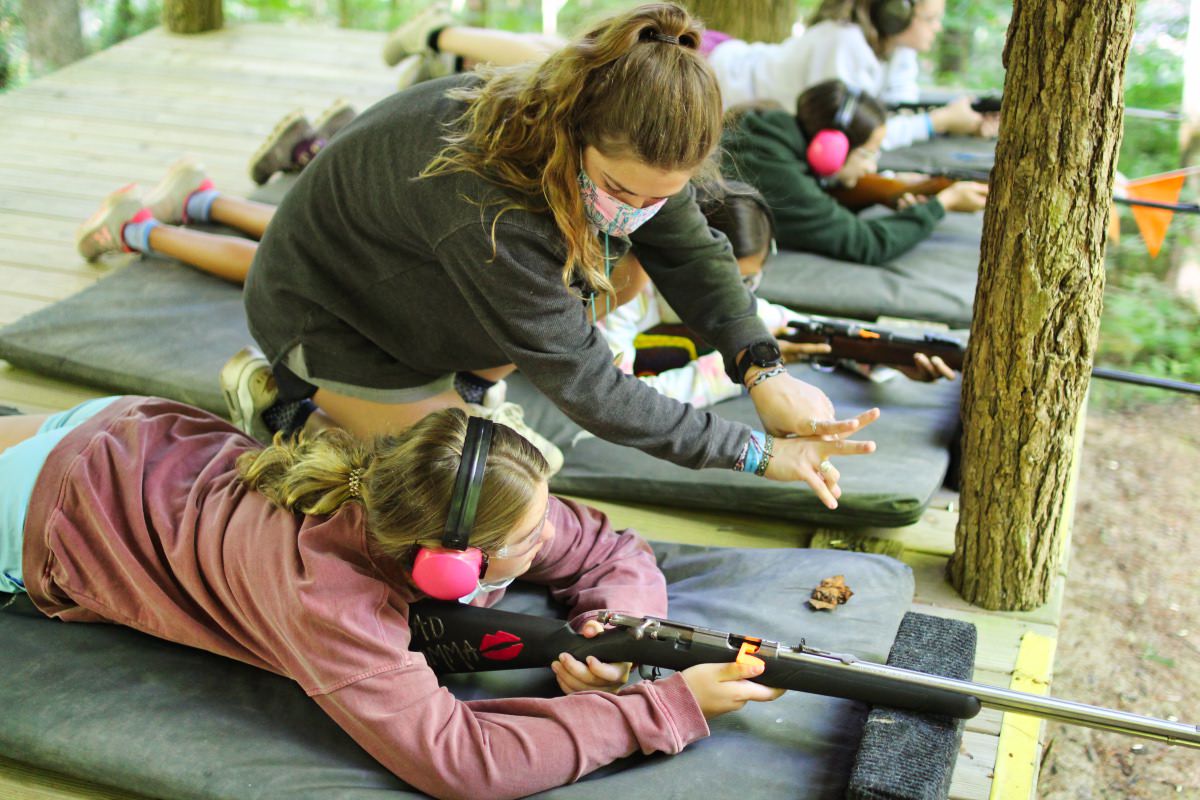 camp girl camp rifle shooting