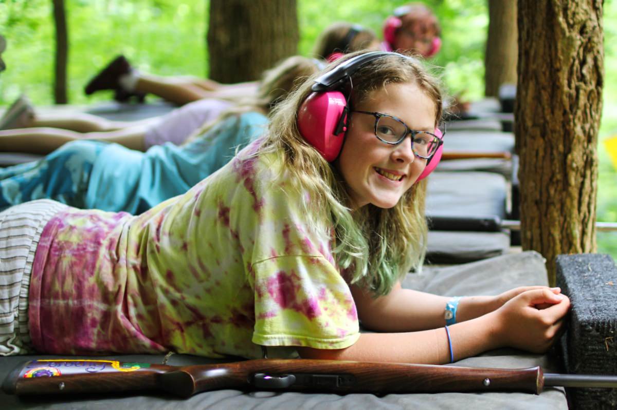 camper girl shooting rifle