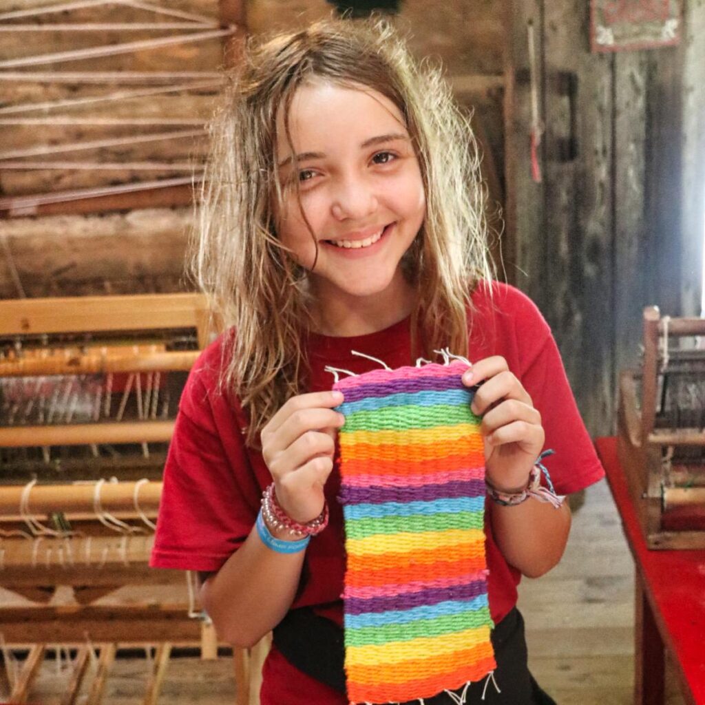 girl holding up weaving