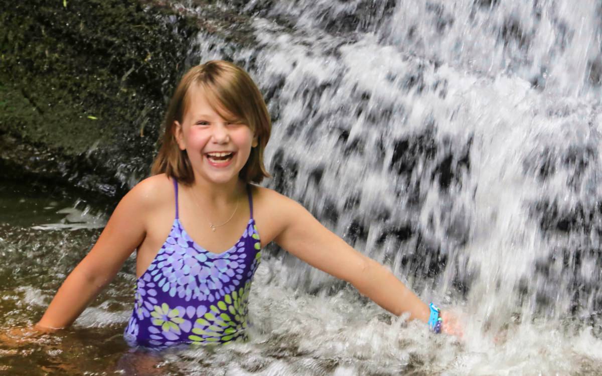 camp girls swimming in waterfall