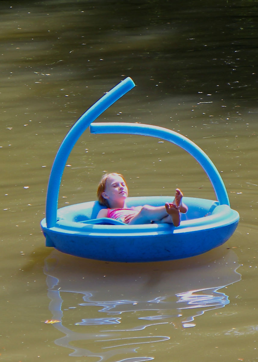 camp girl floating in the lake